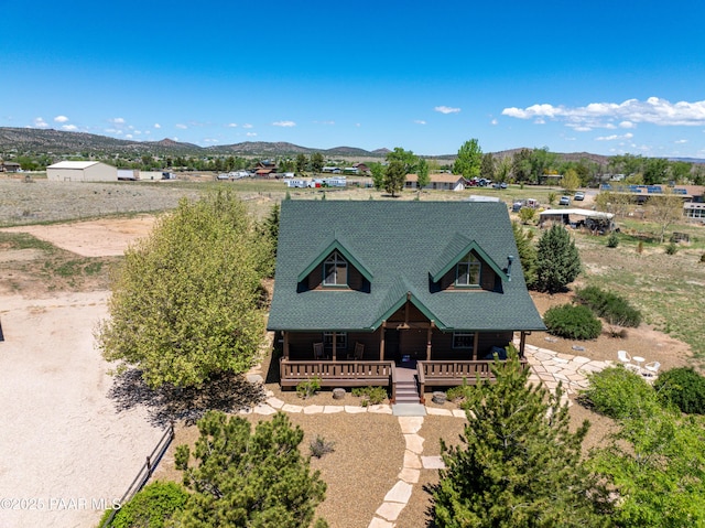1740 W Bumblebee Rd, Chino Valley, AZ 86323 - rustic home with a porch, a mountain view, and a shingled roof