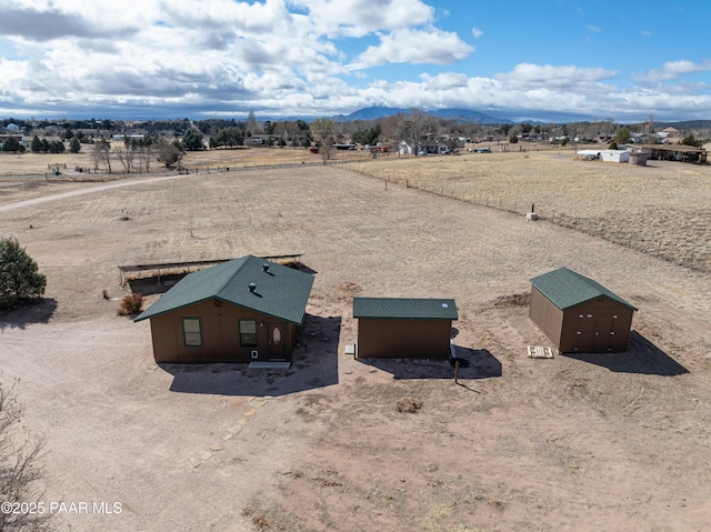 birds eye view of property featuring a mountain view and a rural view
