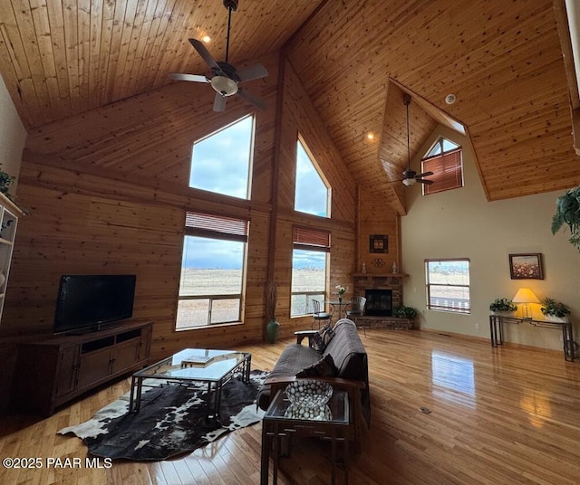 living room featuring wooden ceiling, a fireplace, and hardwood / wood-style floors