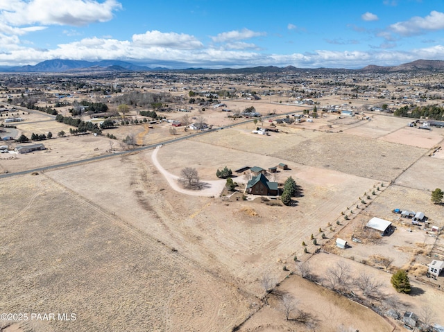 drone / aerial view with a mountain view, a desert view, and a rural view