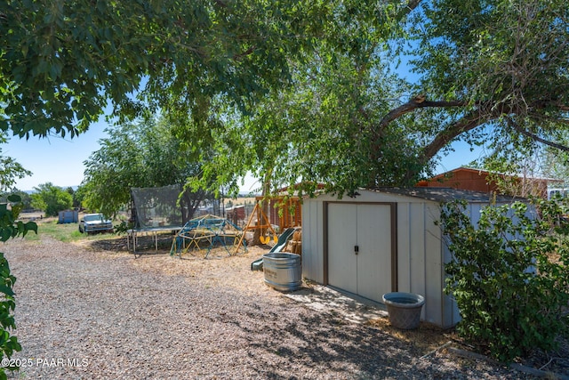2049 N Maricopa St, Chino Valley, AZ 86323 - view of yard with a trampoline, a shed, and a playground