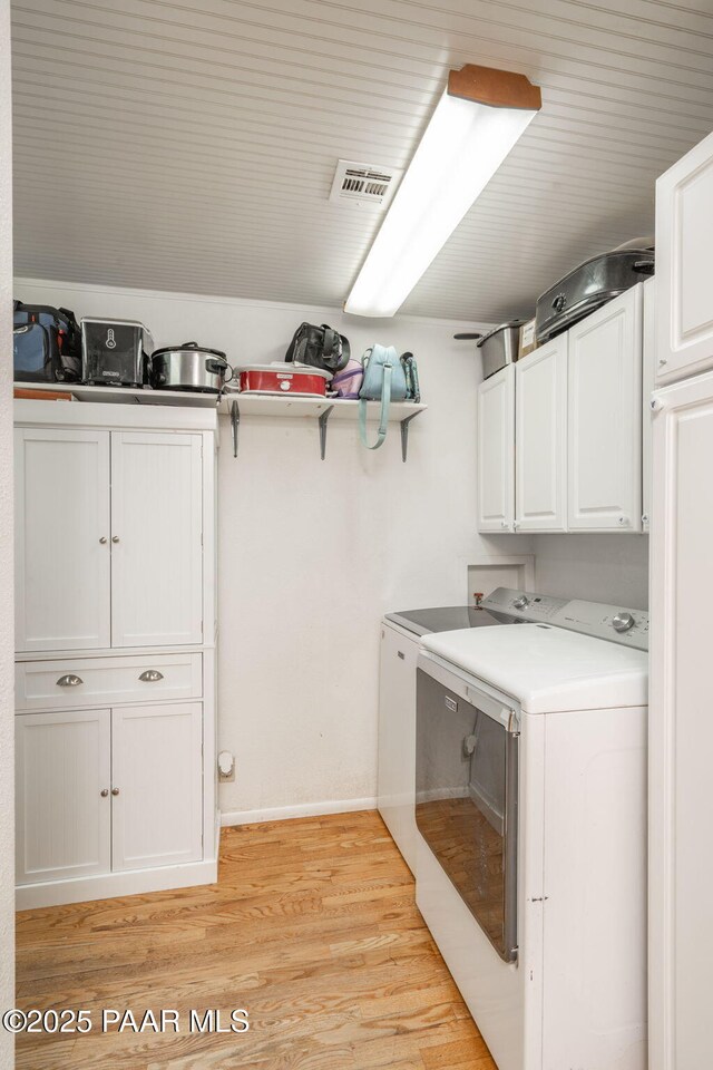 2049 N Maricopa St, Chino Valley, AZ 86323 - washroom with cabinet space, separate washer and dryer, and light wood-type flooring
