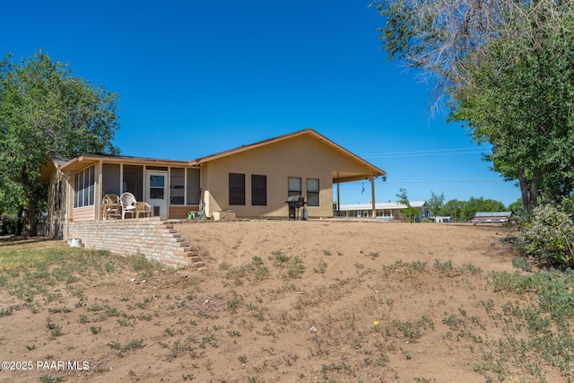 2049 N Maricopa St, Chino Valley, AZ 86323 - back of house with a sunroom and stucco siding
