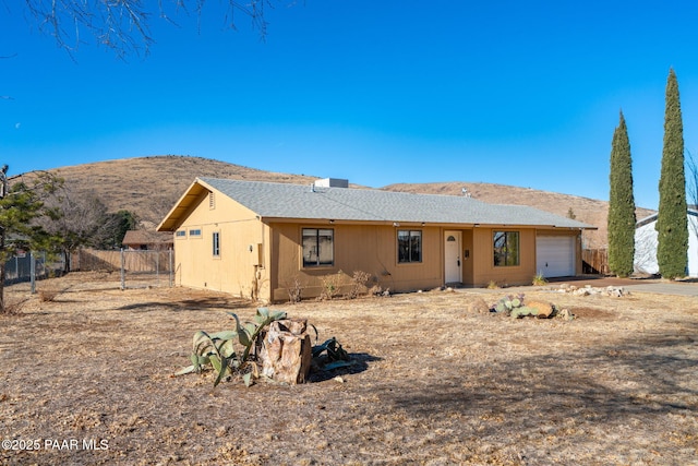 view of front facade with a mountain view and a garage