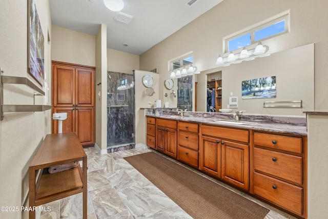 bathroom with walk in shower and vanity