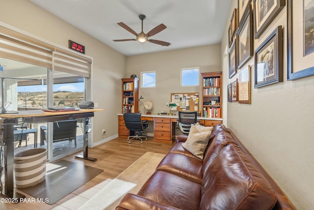 office space with light wood-type flooring and ceiling fan