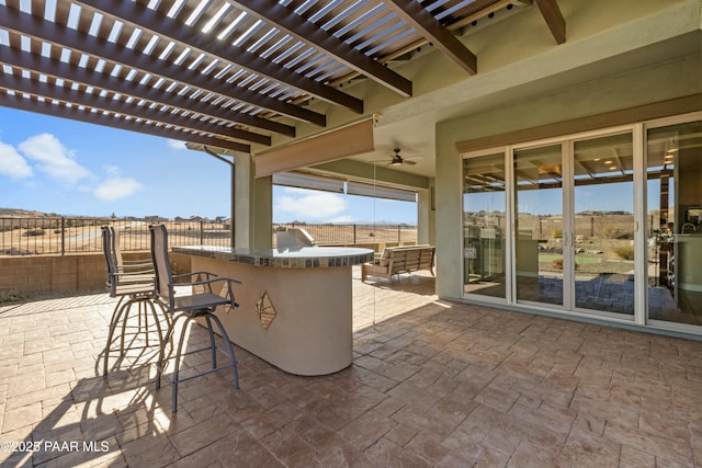 view of patio / terrace featuring ceiling fan, exterior bar, and a pergola