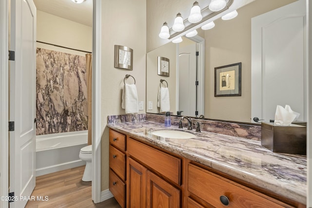 full bathroom with shower / bath combo, toilet, vanity, and hardwood / wood-style flooring