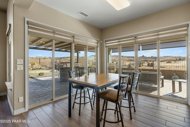 dining room with a healthy amount of sunlight and a mountain view