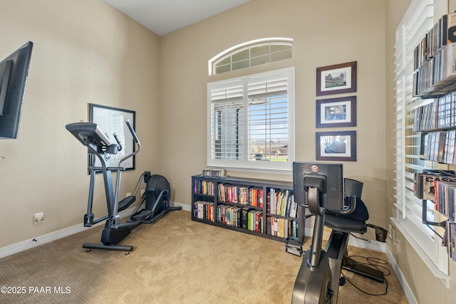 workout room with light colored carpet