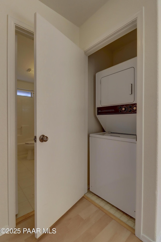 3160 Cascades Dr Unit 16H, Prescott, AZ 86301 - laundry room featuring stacked washer and clothes dryer and light tile patterned floors