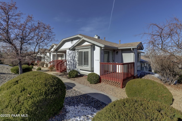 3160 Cascades Dr Unit 16H, Prescott, AZ 86301 - view of front of home featuring a chimney, covered porch, and a shingled roof