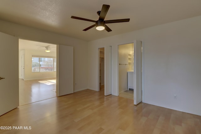3160 Cascades Dr Unit 16H, Prescott, AZ 86301 - unfurnished bedroom with light wood finished floors, ceiling fan, and connected bathroom