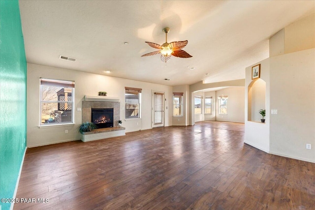 unfurnished living room with dark wood-type flooring, ceiling fan, and lofted ceiling