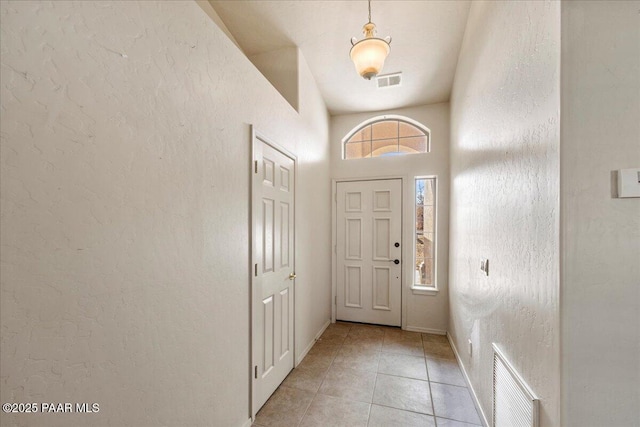 foyer featuring light tile patterned floors