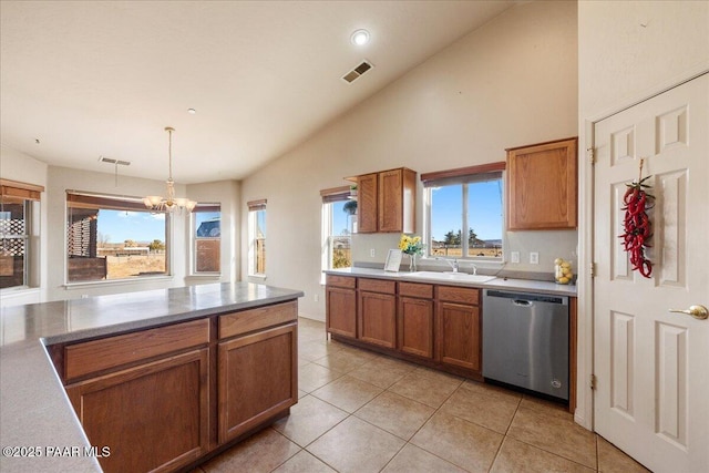 kitchen featuring light tile patterned floors, vaulted ceiling, a chandelier, pendant lighting, and stainless steel dishwasher