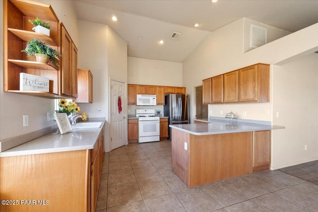 kitchen with kitchen peninsula, sink, white appliances, light tile patterned flooring, and high vaulted ceiling