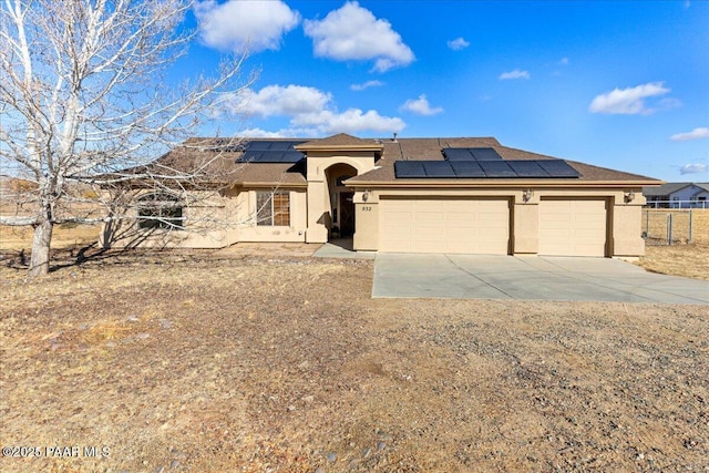 view of front of property with solar panels and a garage