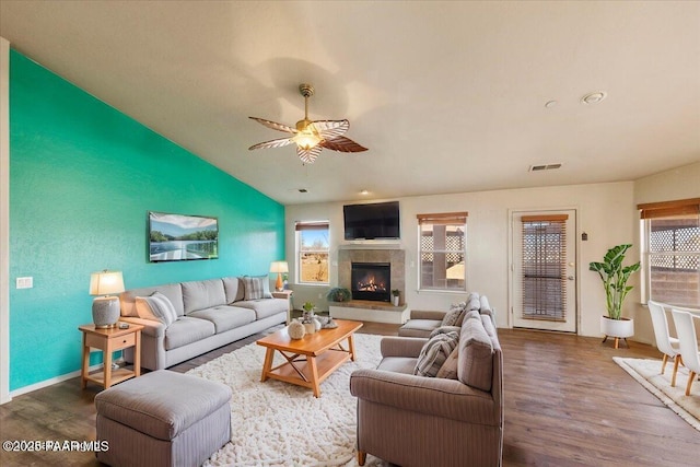 living room featuring ceiling fan, plenty of natural light, hardwood / wood-style flooring, and vaulted ceiling