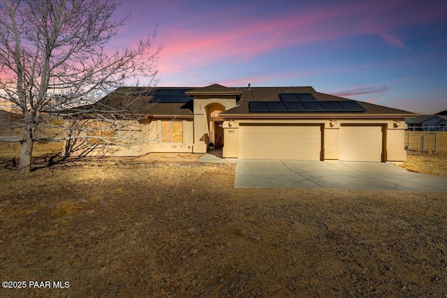 prairie-style home featuring solar panels and a garage