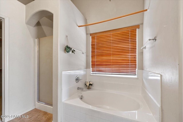 bathroom with separate shower and tub