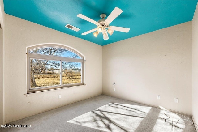 empty room with ceiling fan and carpet flooring