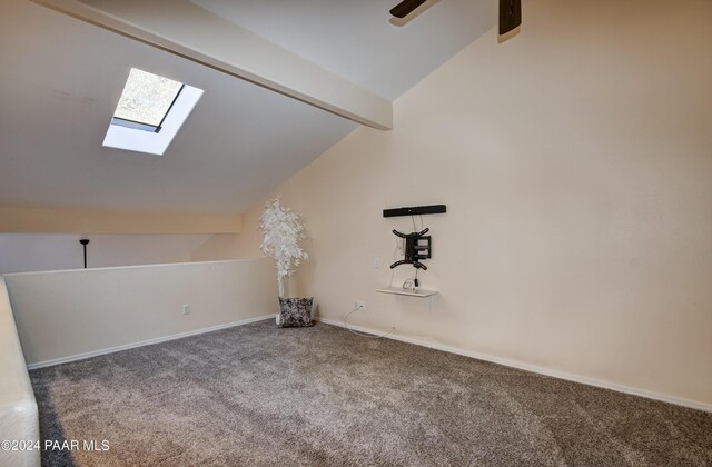 bonus room featuring vaulted ceiling with skylight and carpet