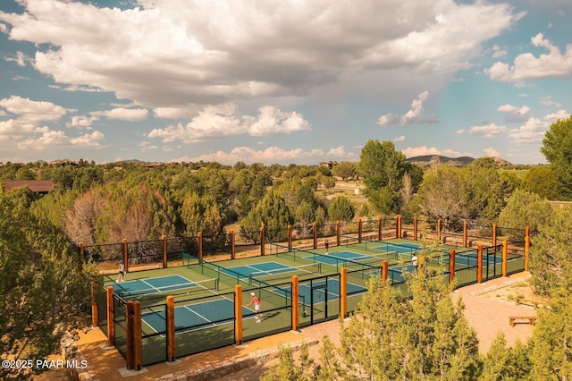 view of tennis court featuring fence