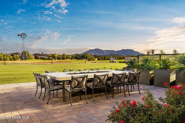 view of patio / terrace featuring outdoor dry bar, outdoor dining area, and a mountain view