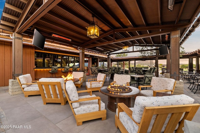 patio terrace at dusk with a fire pit and a gazebo