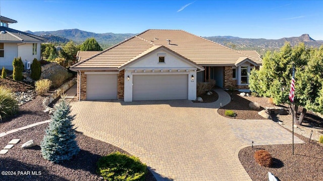 904 Daybreak Dr, Prescott, AZ 86303 - ranch-style house with a mountain view, a garage, driveway, and stone siding