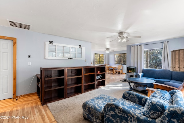 living room featuring ceiling fan and hardwood / wood-style flooring