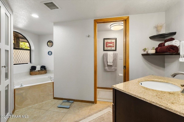 bathroom featuring a garden tub, visible vents, a textured ceiling, tile patterned flooring, and walk in shower