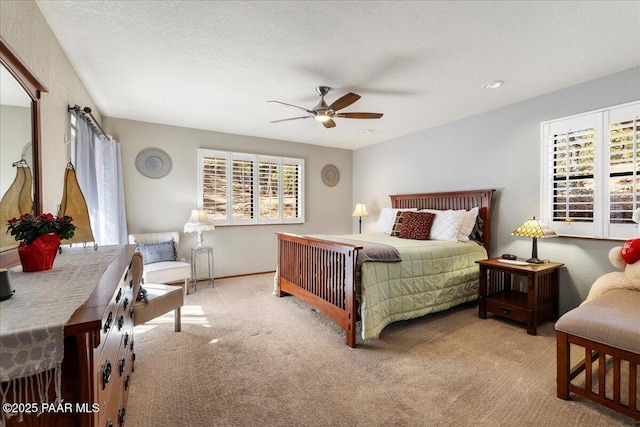 bedroom with a textured ceiling, ceiling fan, and carpet