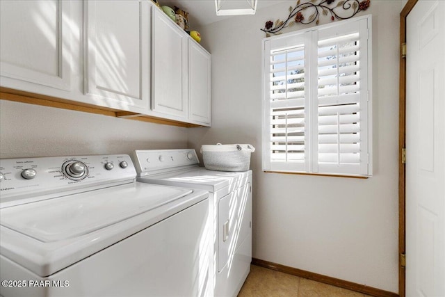 laundry area featuring washer and clothes dryer, cabinet space, and baseboards