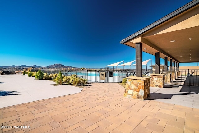 view of patio / terrace with a fenced in pool and a mountain view