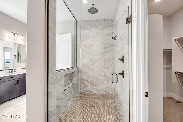 bathroom with vanity and a shower with shower door