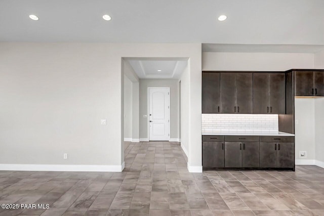 kitchen with dark brown cabinetry and backsplash