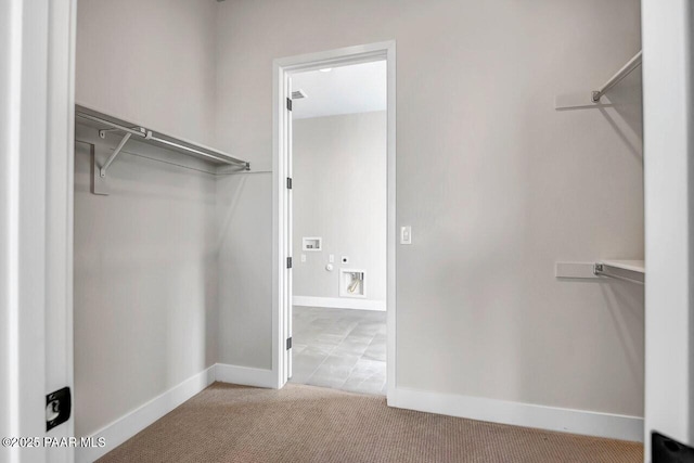 spacious closet with light colored carpet