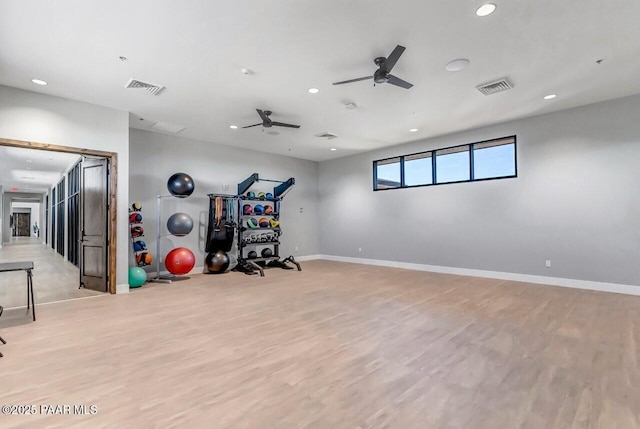 exercise area with ceiling fan and light hardwood / wood-style floors