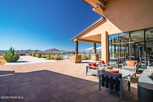 view of patio / terrace with a mountain view and an outdoor hangout area