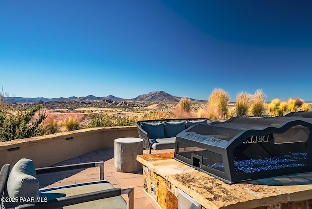 view of patio with a mountain view and outdoor lounge area