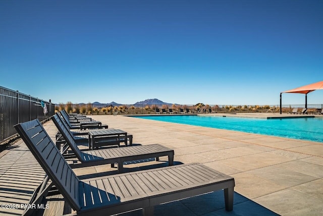 view of pool featuring a mountain view and a patio