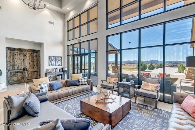 living room featuring a mountain view and a notable chandelier