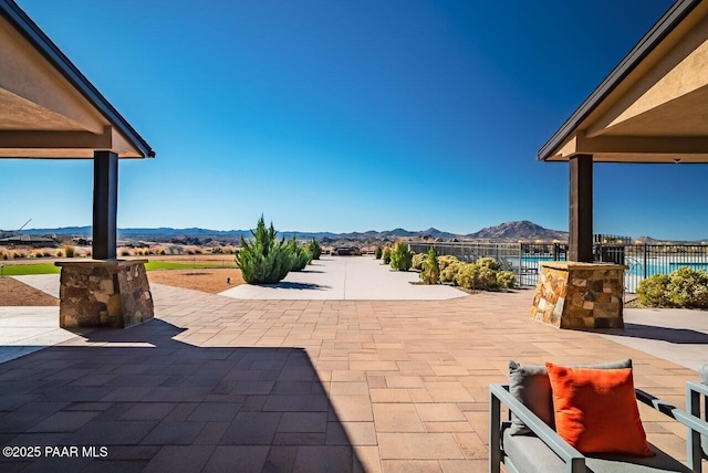 view of patio featuring a pool and a mountain view