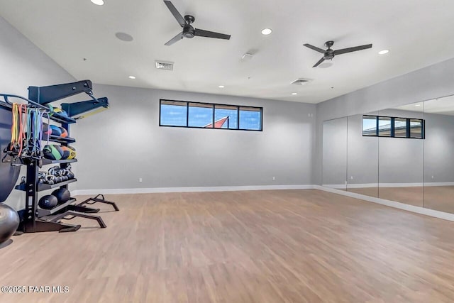 exercise room featuring wood-type flooring and ceiling fan