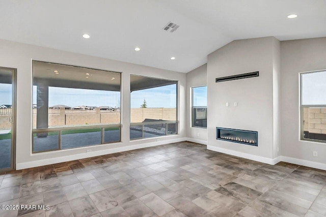 unfurnished living room featuring vaulted ceiling