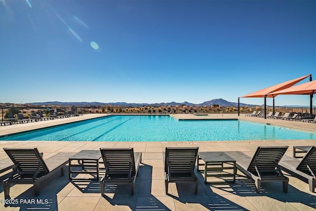 view of pool with a patio and a mountain view