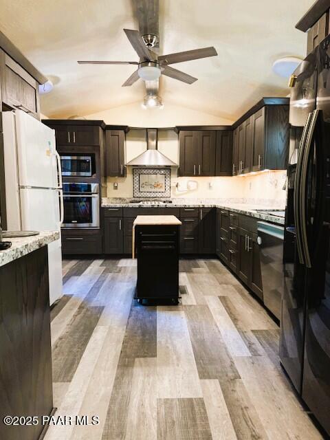 1696 W Linger Ln, Prescott, AZ 86303 - kitchen featuring appliances with stainless steel finishes, wall chimney exhaust hood, lofted ceiling, a ceiling fan, and light wood-style floors