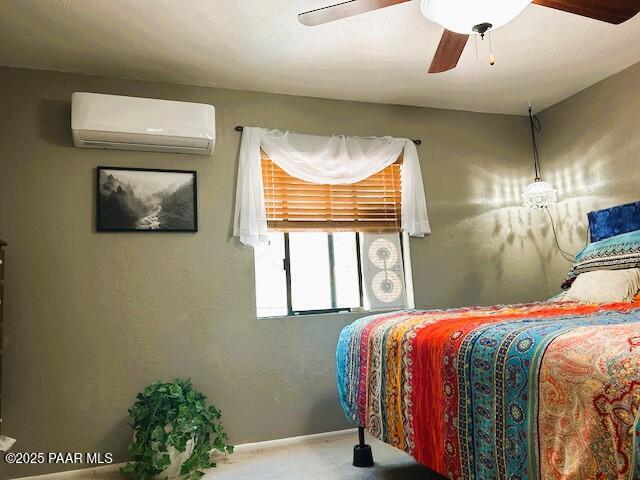 1696 W Linger Ln, Prescott, AZ 86303 - bedroom with an AC wall unit, carpet, and a ceiling fan